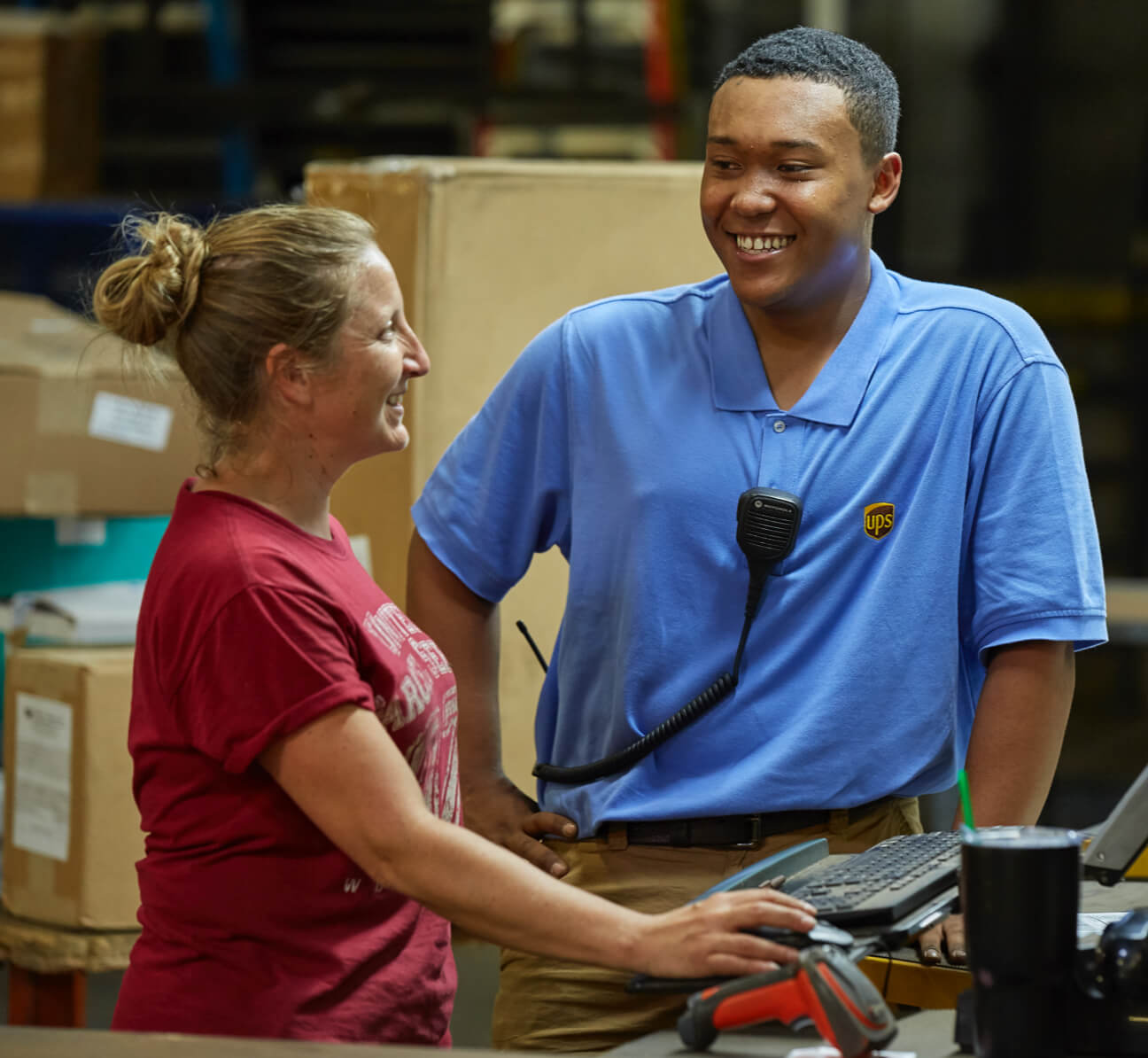 Two people chatting at a UPS warehouse