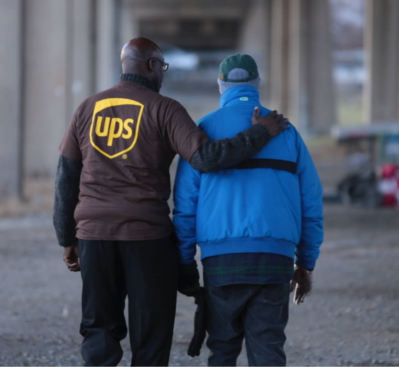 UPS worker with arm around man
