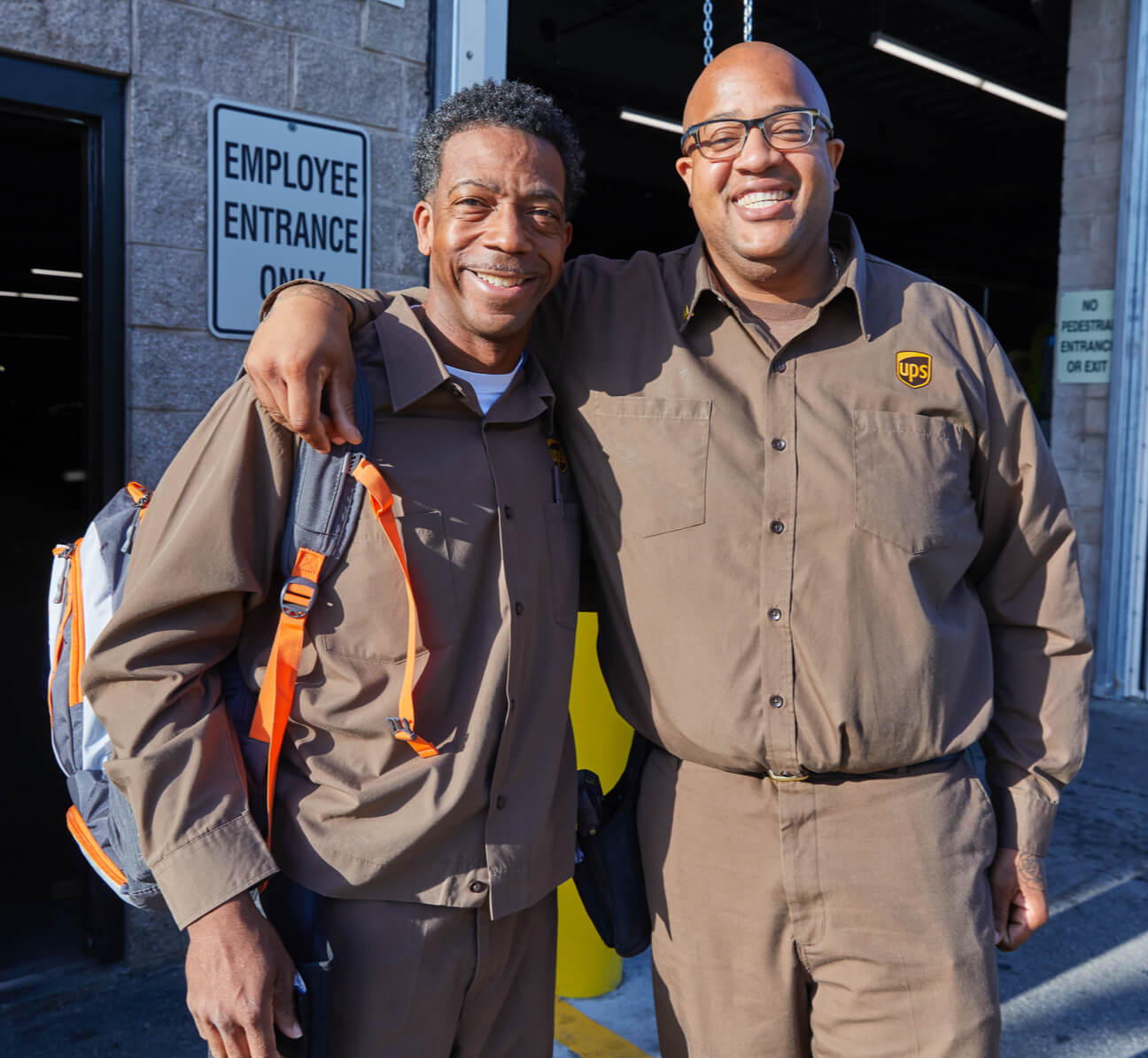 UPS worker with arm around man