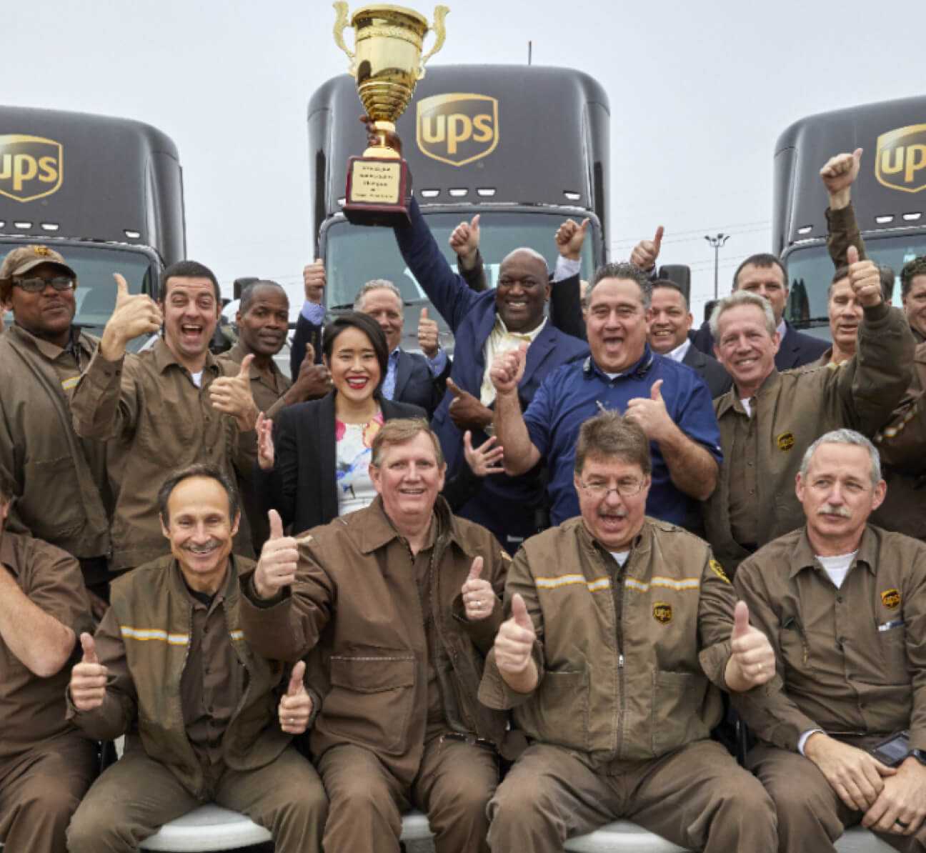 UPS workers holding a trophy