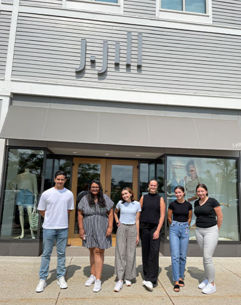 group of people posing for photo in front of J.Jill office