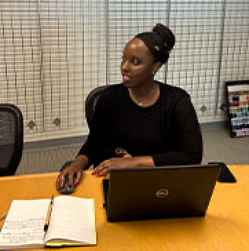 a woman is working on her laptop