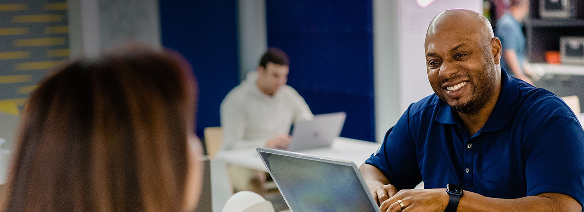 USAA professional on laptop smiling