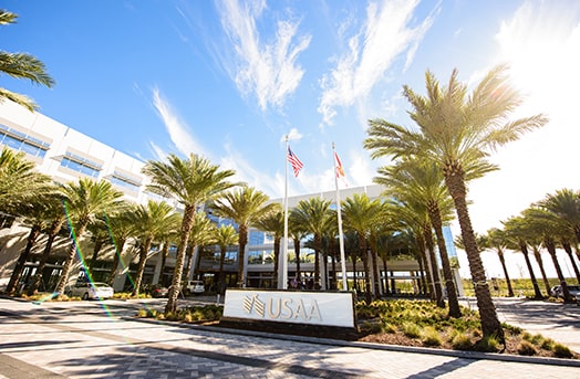 The USAA office sign showing the entrance to the Tampa office with palm trees all around it