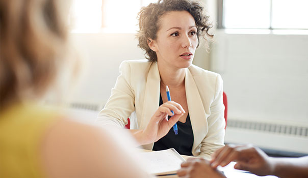 Woman talking with others at a table