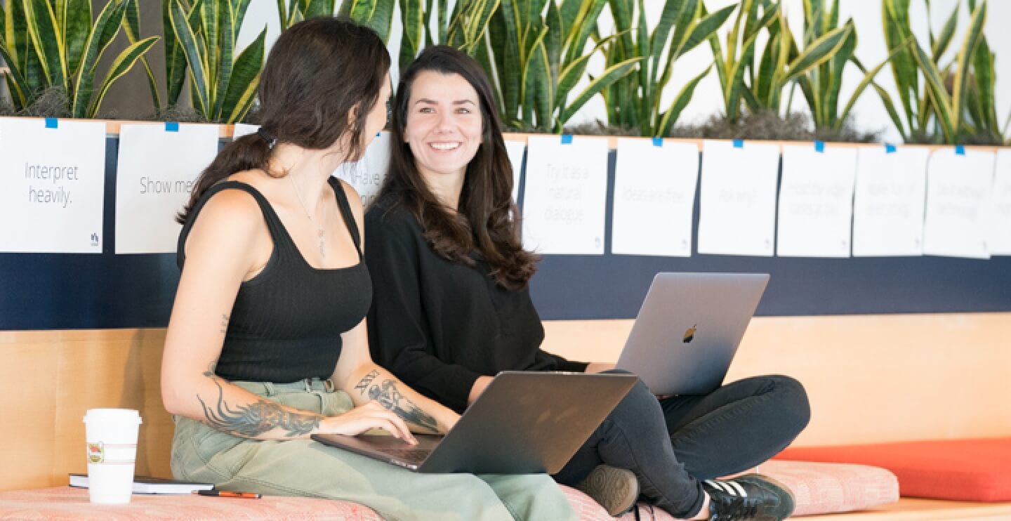 Two employees on their laptops