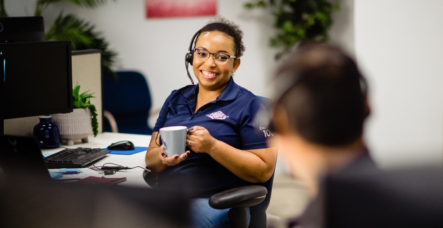 USAA employee sitting at an office desk