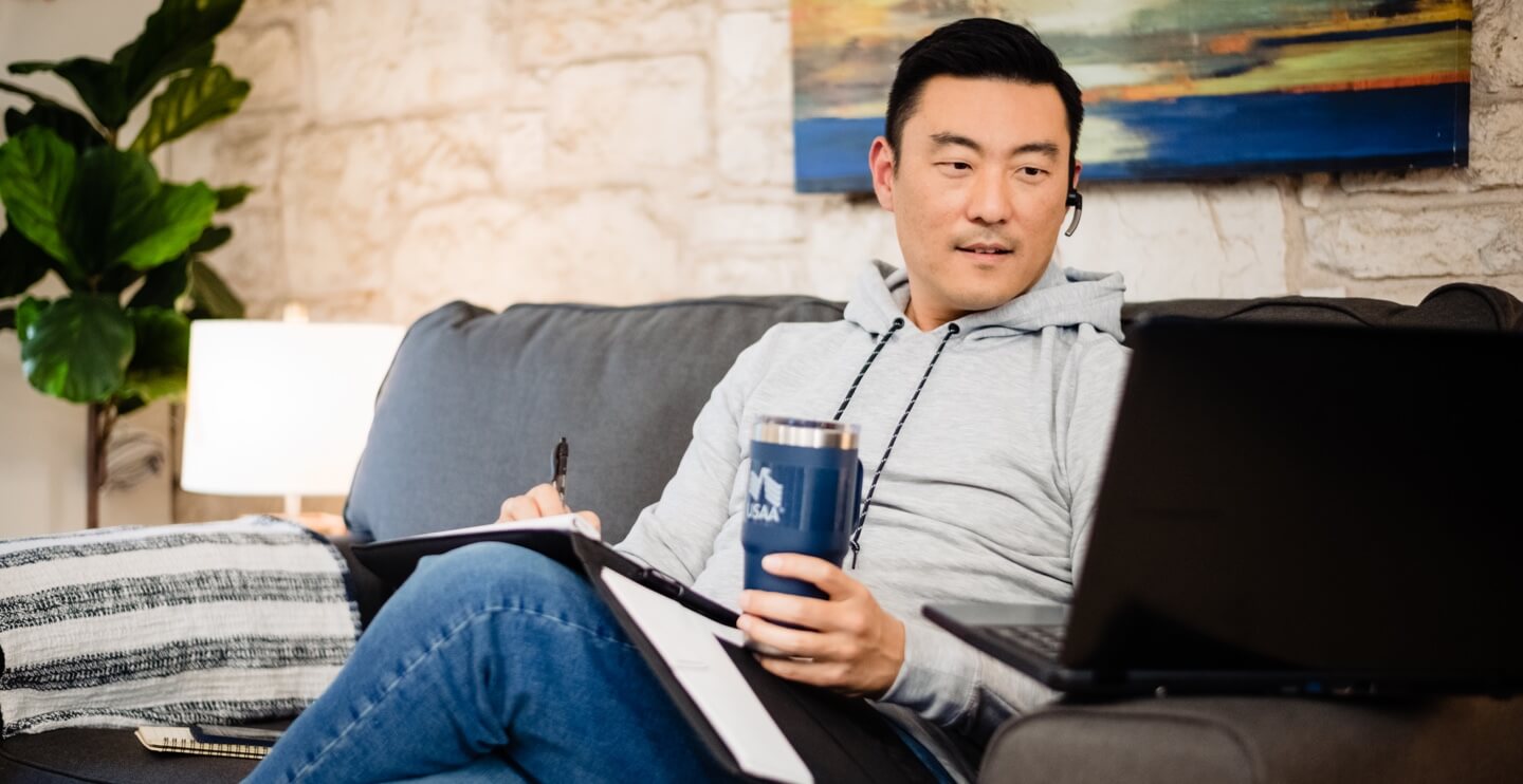 USAA employee listening to a headset earpiece