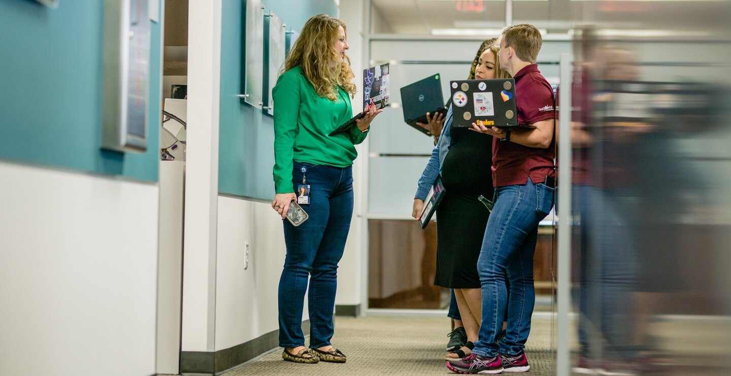 Employees standing in a hall and chatting