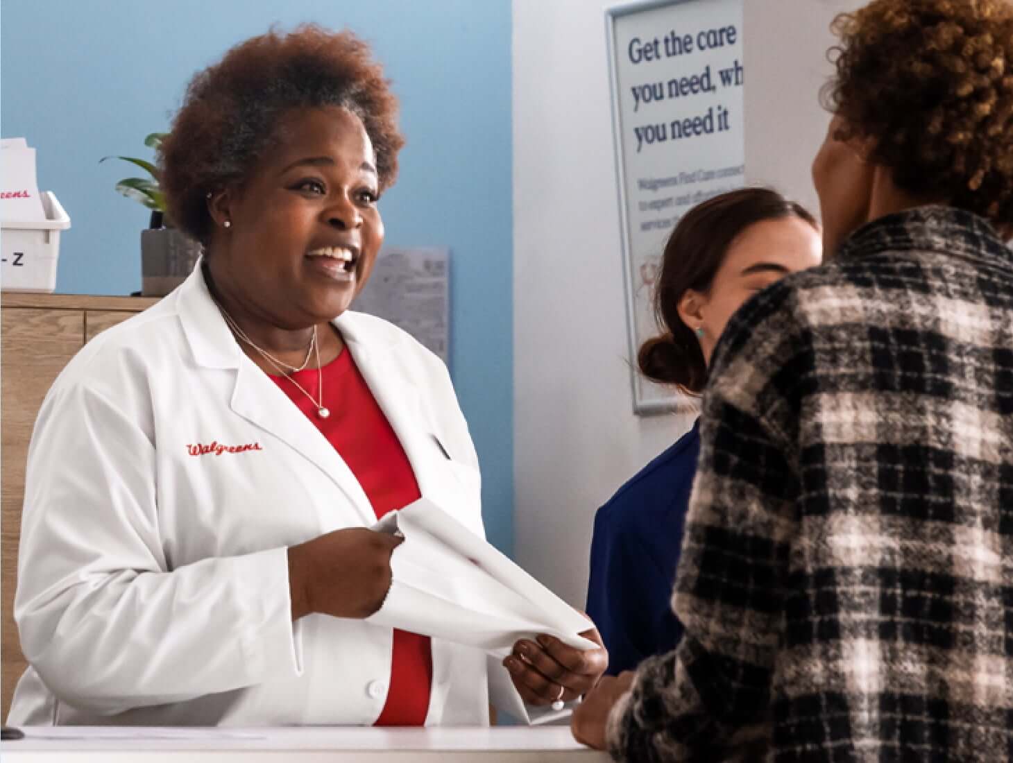 Walgreens pharmacist helping a customer at the pharmacy counter