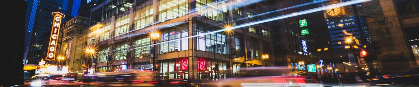 A night shot of Walgreens near the historic Chicago Theater.