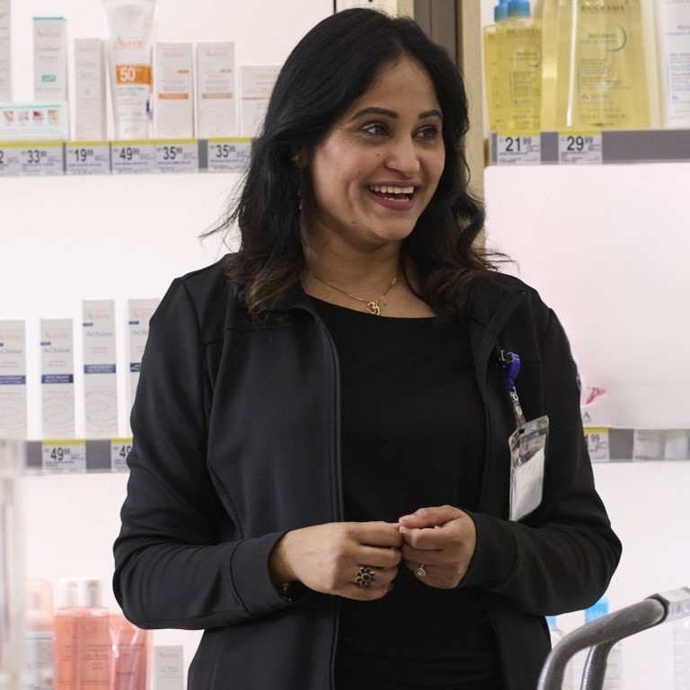 Beauty and wellness consultant smiling in cosmetics aisle