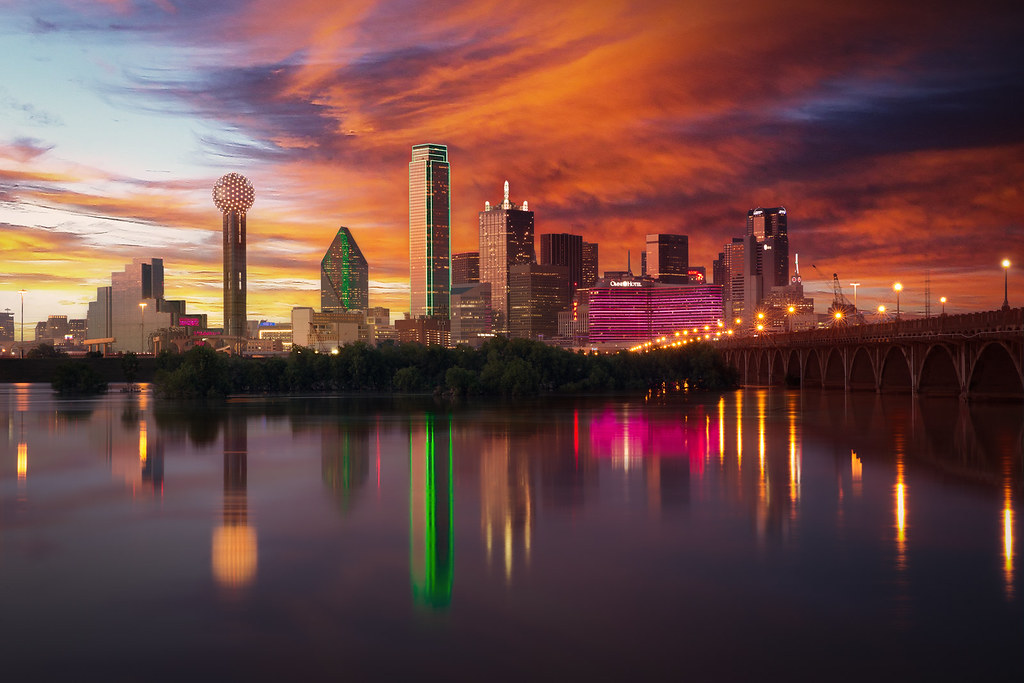 Team member in blue uniform on a yellow bike in a warehouse