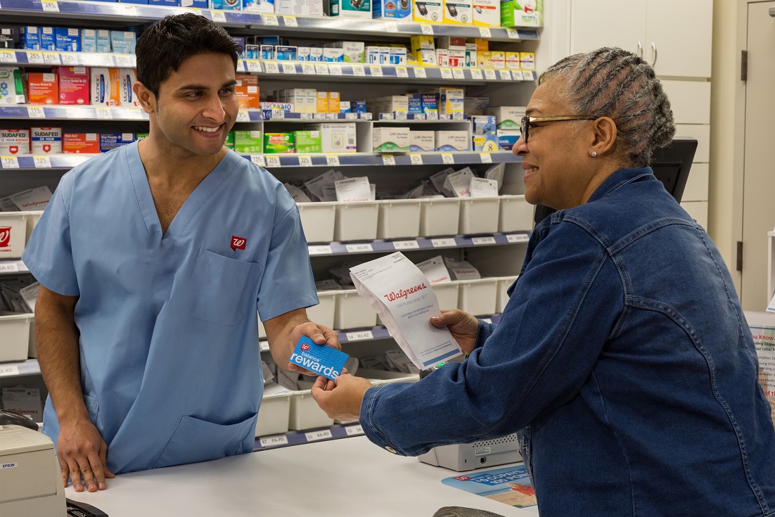 Pharmacy technician helping a customer