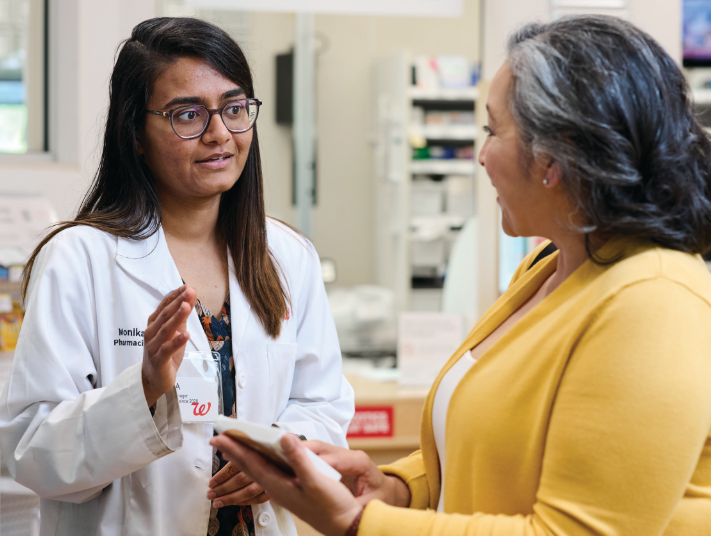 Team member in blue uniform on a yellow bike in a warehouse