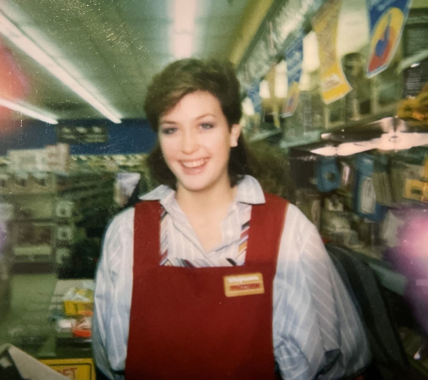 Service clerk Tracie in a maroon Walgreens vest in the 1980's