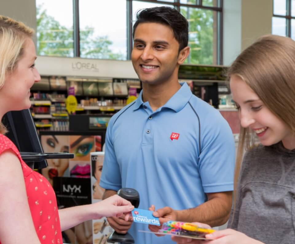 Cashier scanning a customer's rewards card