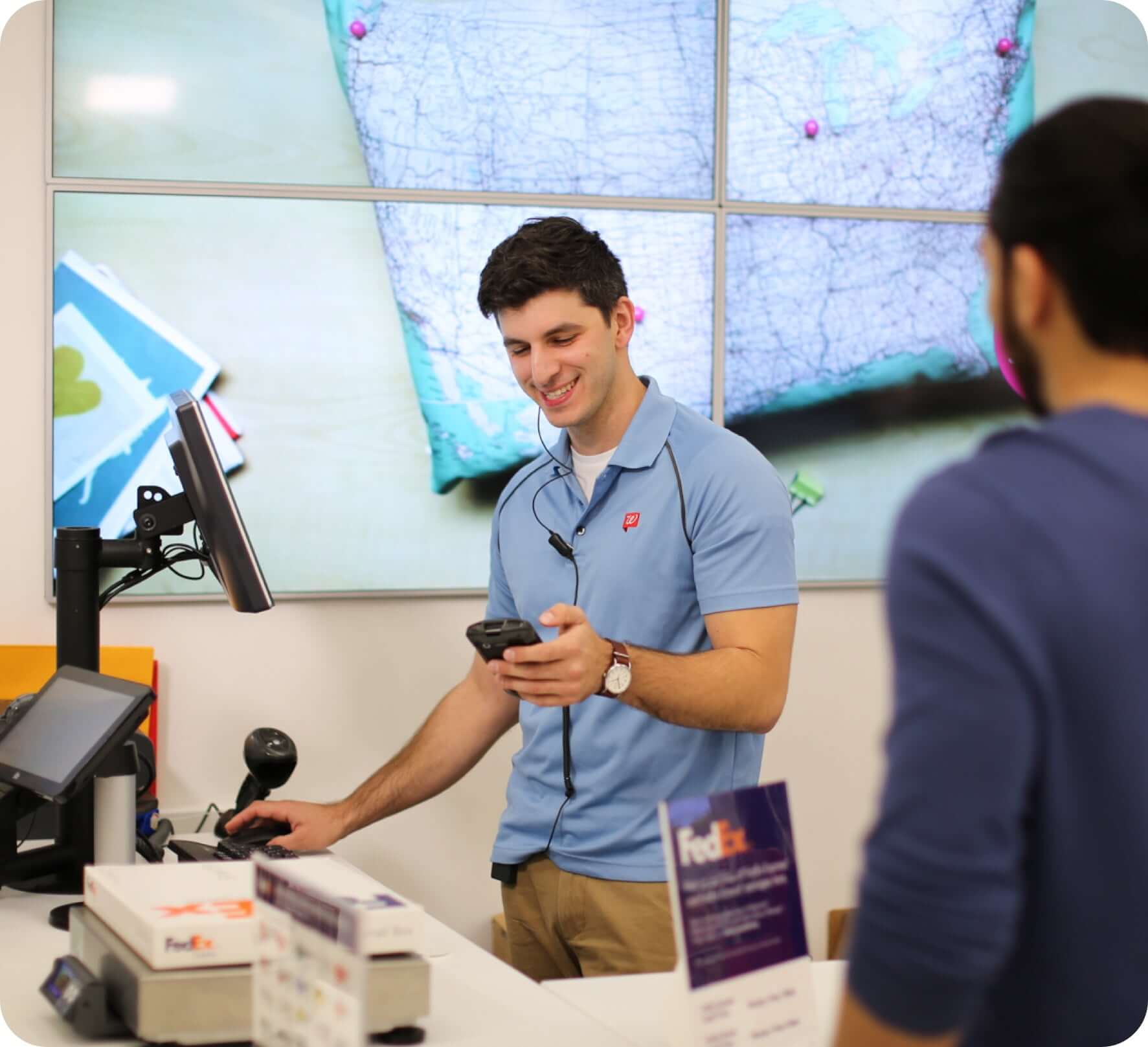 Employee shipping package at fedex drop off