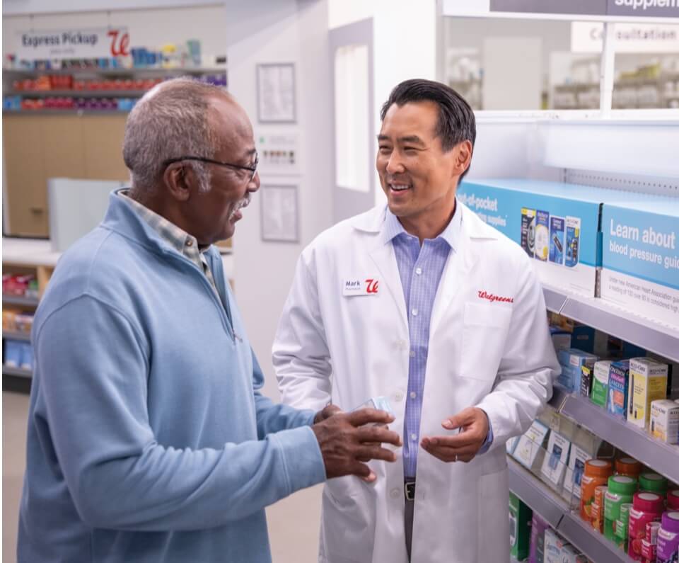 Pharmacist assisting older customer