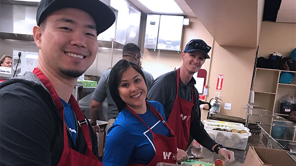 Employees posing for a picture while doing community service