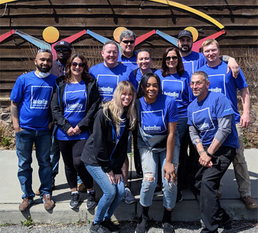 Employees posing for a picture after doing community service