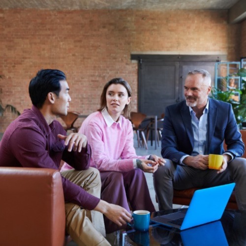 three people sitting in a common area