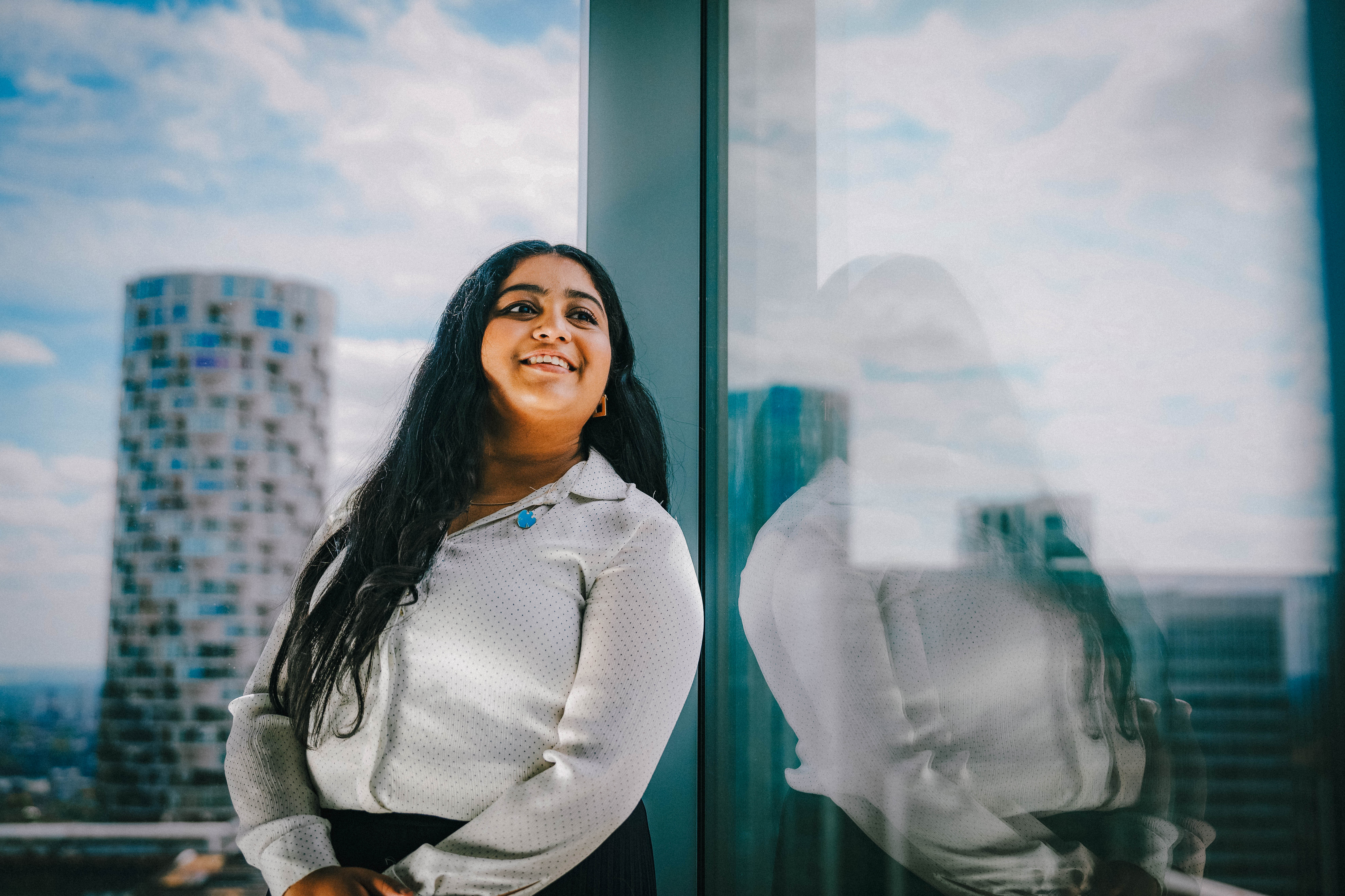 a woman against a wide window