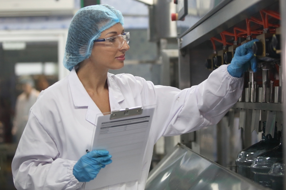 Female in white lab coat and blue hair net