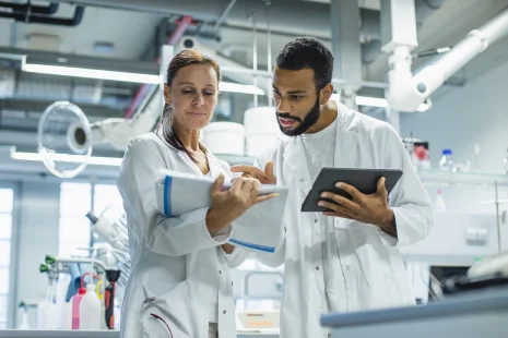 Two employees reviewing work