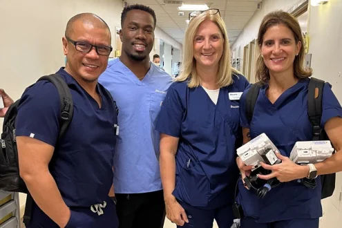 Four doctors standing and smiling