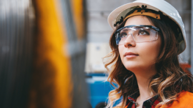 Female worker with hardhat and safety goggles