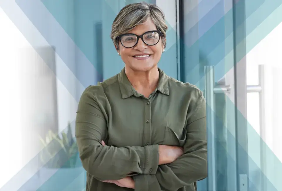 A confident middle-aged woman with short gray hair and glasses