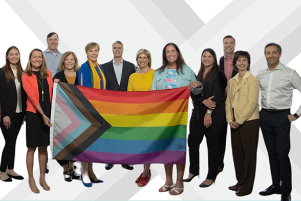 A group of baxter employees holding pride flag