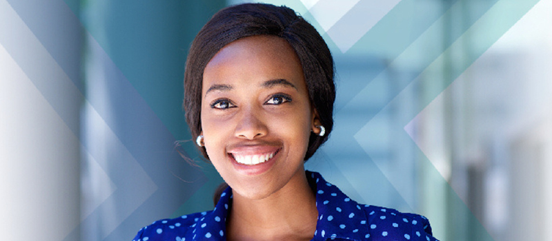 Woman smiling for the camera wearing a blue blouse