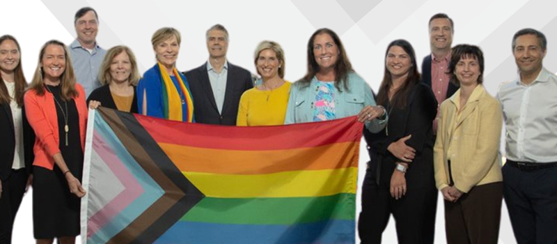 Group of people holding up a pride flag