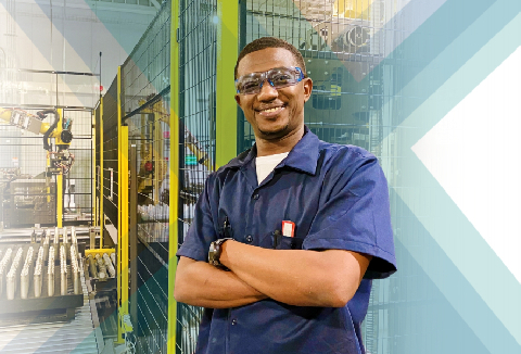 Baxter employee smiling with safety goggles on