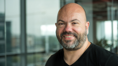 Male in black t-shirt, smiling