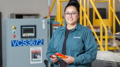 Female technician standing in facility