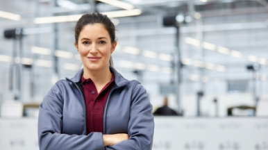 Female employee standing in facility