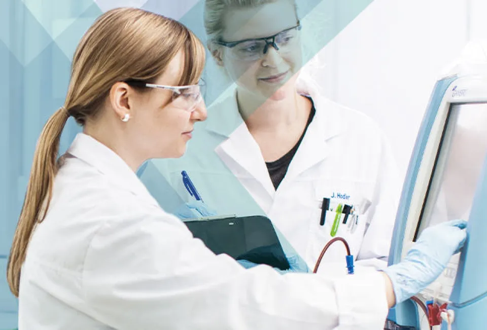 Two female employees working on machine