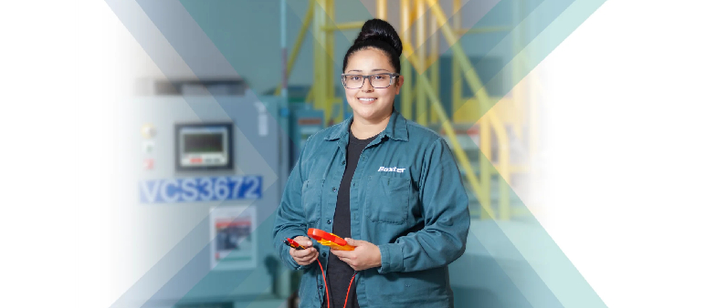 Woman in blue shirt and glasses holding a red tool