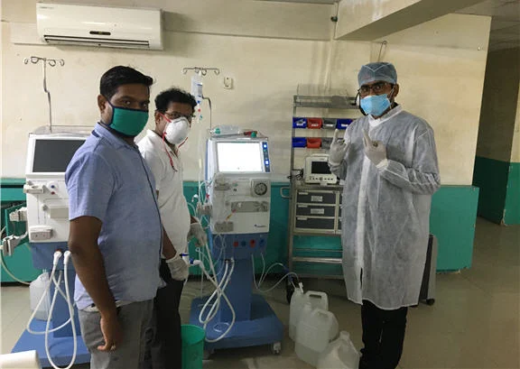 Field Service Engineers standing in front of a hemodialysis machine