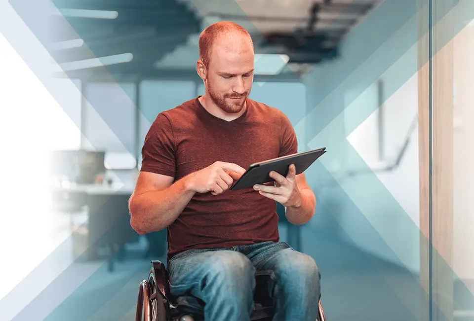 Man in wheelchair using a tablet device