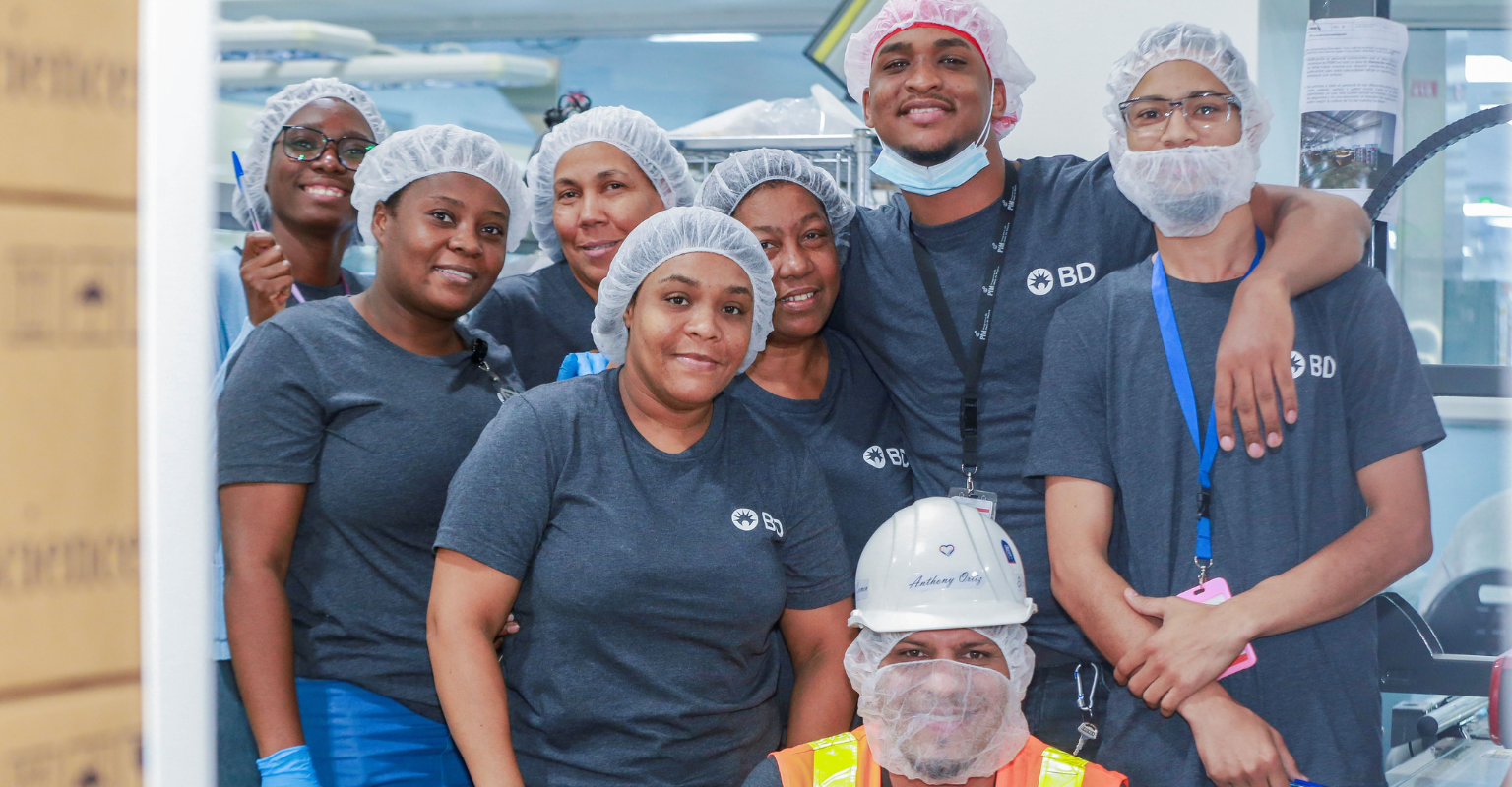 Group of BD associates wearing protective equipment in a manufacturing facility.