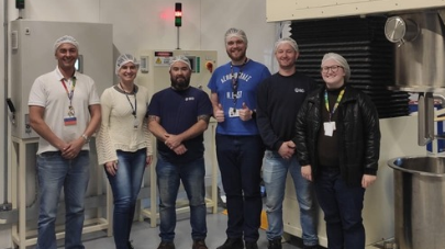 BD associates standing together in a manufacturing facility