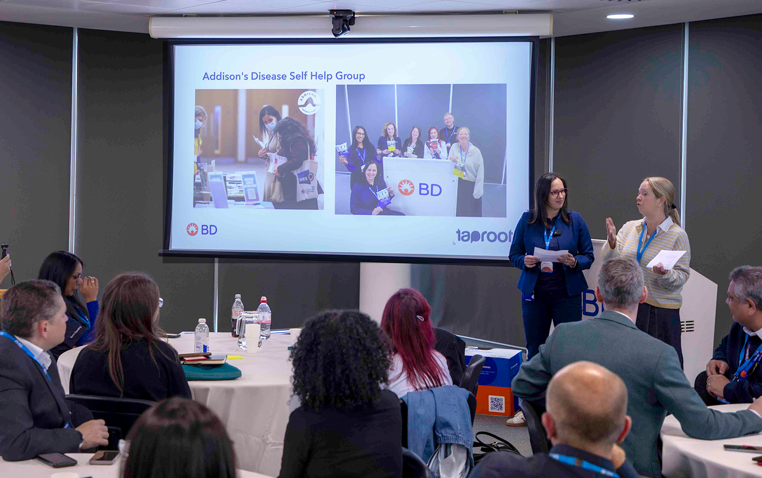 Speakers presenting at the Difference in a Day Marathon event while BD associates and guests participate in a group discussion session.