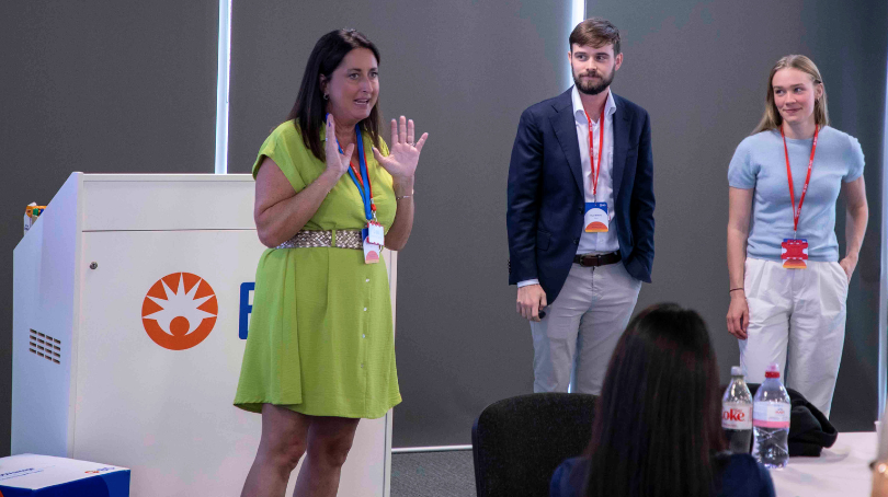 BD associates and Taproot Foundation associates presenting at the front of a large atrium room.