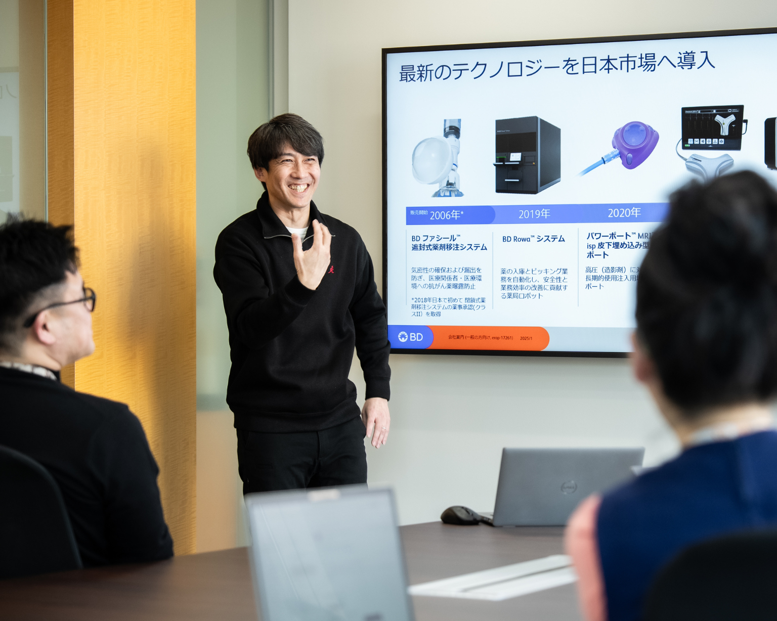 Man presenting to a group of people with presentation on screen