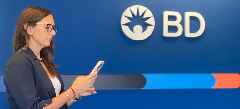 Woman looking at her phone in a BD office