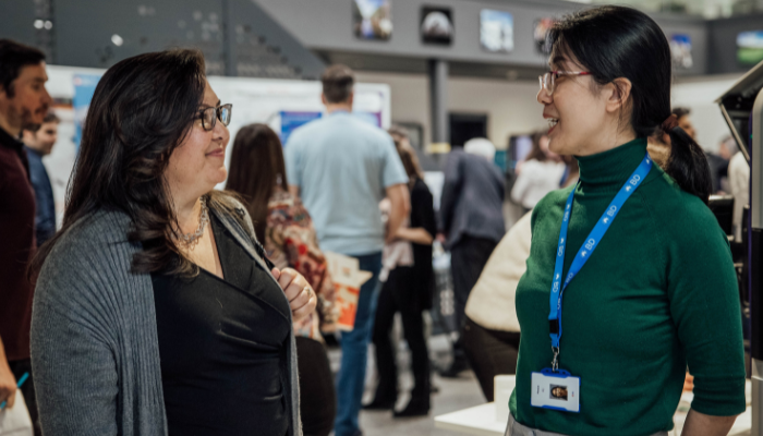 Two women chatting in a BD office
